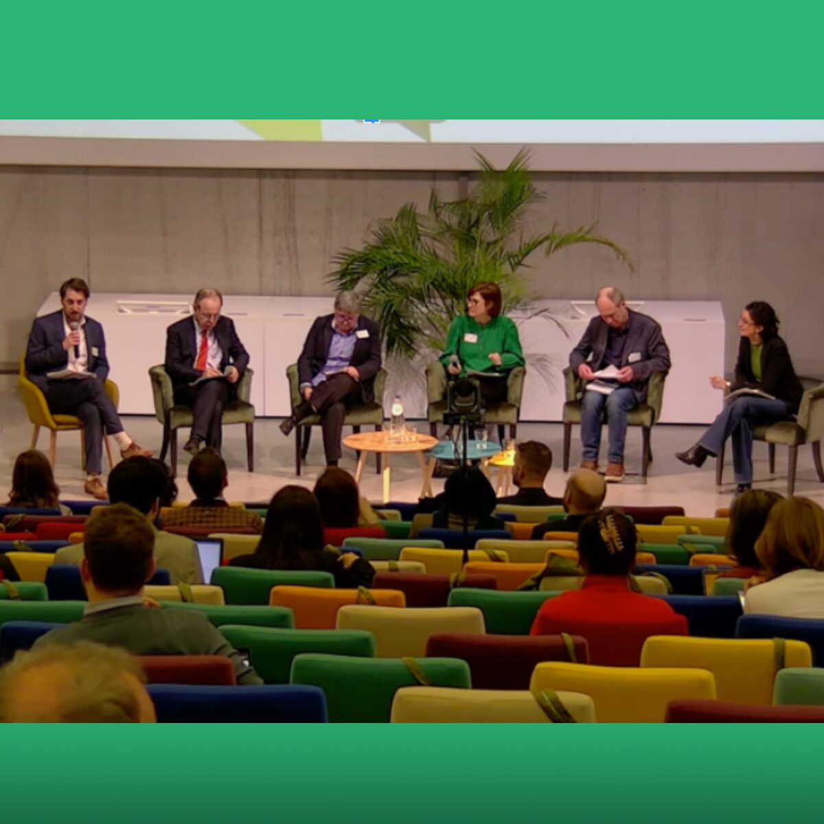 People on a panel at a conference